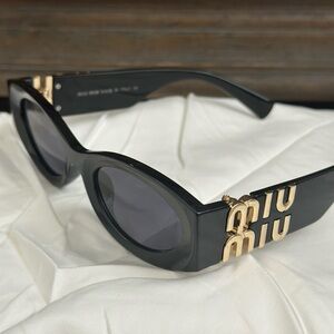 Miu Miu Black and Gold Sunglasses